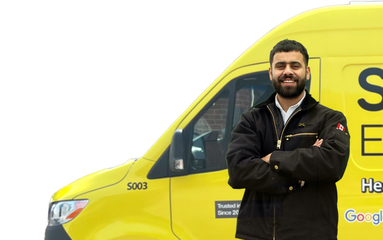 Two Shines technicians smiling in front of their green service van, wearing issued jackets during an on-site consultation.